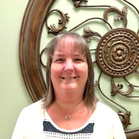 Amy, Office Manager at iGo Technology, smiling in the iGo office