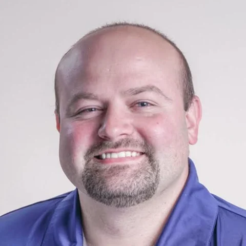 Rocky, Network Engineer at iGo Technology, smiling in a blue polo shirt