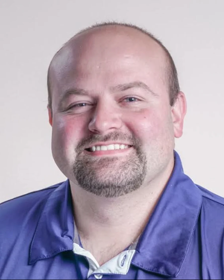 Rocky, Network Engineer at iGo Technology, smiling in a blue polo shirt