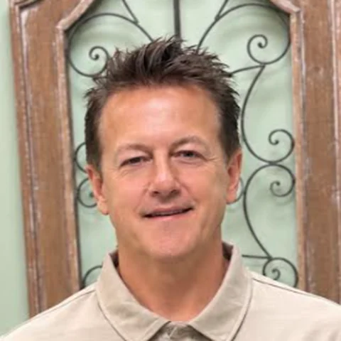 Steve, President of iGo Technology, smiling in an iGo polo shirt